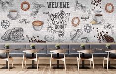 a wall mural in a restaurant with coffee and doughnuts on the wall, along with wooden tables