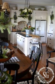 the kitchen is decorated for christmas with greenery and pine cones on the countertop