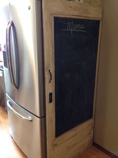 a refrigerator with a chalkboard on the door and menu written on it's side