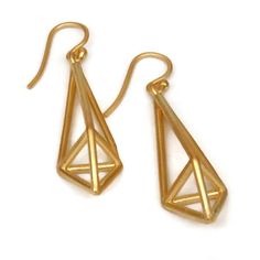 These geometric gold vermeil earrings are part of my new crystal series. Intersecting line create a modern shape inspired by cut gemstone shapes. Elongated pyramids, . They are open and light have nice presence the ear. Cast in sterling silver and vermeil plated with a matte finish. Size: Inclusive of ear wire they hang down 1.8 inches 45 mm the gold shape is 35 x 11 mm. The modeled shot is the same pair oxidized black. I have other small silver earrings https://www.etsy.com/shop/SHERIBERYL?sect Modern Geometric Linear Earrings For Gifts, Gold Geometric Earrings For Formal Occasions, Modern Gold Linear Earrings For Gift, Modern Geometric Gold Jewelry, Modern Geometric Gold Earrings, Modern Gold Geometric Earrings, Modern Gold Faceted Jewelry, Modern Gold Linear Pierced Earrings, Gold Geometric Jewelry With Matching Earrings