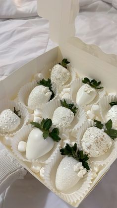 a box filled with white chocolate covered strawberries