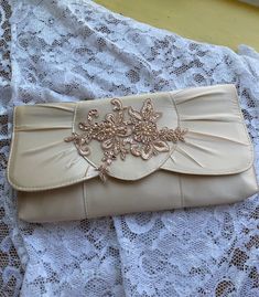 "Beautiful purse for special occasion, Wedding or Church ceremony, BRIDESMAIDS, Mother of the bride or of the Groom. The lace applique is cotton with hand sewn beads, pearls, and sequins as shown in the picture. COLORS:  PINK CHAMPAGNE/ROSE GOLD (AS PICTURED) CHAMPAGNE/ROSE GOLD IVORY/ROSE GOLD WHITE ROSE GOLD Dimentions: 11\" x 5.5\" Shoulder strap cord, may be hidden when not in use. NO RETURNS, NO EXCHANGES, FINAL SALE! PEASE CONTACT FOR ANY ADDITIONAL QUESTIONS." Elegant Embroidered Cream Evening Bag, Elegant Cream Embroidered Evening Bag, Elegant Embellished Lace Bridal Accessories, Embellished Cream Evening Bag For Wedding, Elegant Embroidered Wedding Bridal Accessories, Elegant Embroidered Bridal Accessories For Wedding, Formal Cream Embroidered Evening Bag, Elegant Lace Bridal Accessories For Formal Occasions, Formal Lace Bridal Accessories