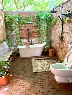 an outdoor bathroom with brick walls and flooring, including a bathtub in the center