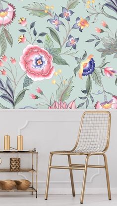 a chair and table in front of a floral wallpaper