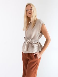 "ALEXANDRA is a linen tie waist top. DETAILS - Cap sleeve design - Crew neck - Self tie belt - 100% lightweight European linen fabric - Cut and sewn to order just for you in our studio COLOR - Beige, you can also choose other colors above - Fabric samples are available here https://www.etsy.com/listing/586569696/linen-fabric-samples SIZING & FIT - Relaxed, loose fit - Length (shoulder to hem) is approximately 22.5 inches / 57 cm - Bust (pit to pit) is approximately 20.5 inches / 52 cm - Shou Linen Tie Waist Top For Summer, Summer Linen Top With Tie Waist, Summer Linen Tops With Tie Waist, Chic Beige Linen Blouse, Beige Linen Blouse For Workwear, Chic Linen Tops For Workwear, Spring Workwear Belted Tops, Elegant Belted Summer Top, Elegant Belted Top For Summer