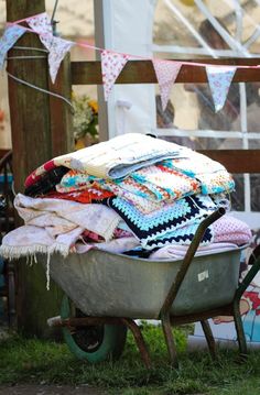 a wheelbarrow filled with lots of blankets