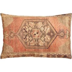 an old rug pillow on a white background with a brown and orange design in the middle