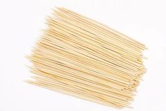 a pile of uncooked pasta sticks on a white background