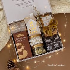 a christmas gift box filled with chocolates, marshmallows and other holiday treats