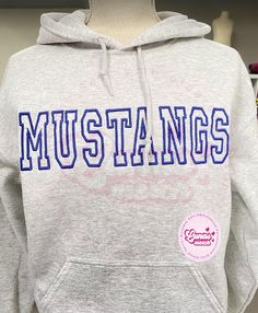 personalize  your hoodie with your mascot or school name. embroidered with a varsity font  chose the thread color you want. and the hoodie color too. make it as you want it to be.     Note: Our Sweatshirts run true to size, so if you desire an oversized fit please order a size up. Refund and Exchange : We cannot refund or exchange an item unless it was defective or damaged. We will do our best to make sure you are satisfied with your purchase so please inform us if you have any problem with our products. Unisex heavy blend sweatshirts are the idea of comfort and relaxation. The material is a thick blend of both cotton and polyester. This creates a plush, soft and warm feeling when wearing. A spacious kangaroo pocket is found in the front of the hoodie. The hoodies drawstring is the same co Varsity Font, Bulldog Sweatshirt, School Birthday, Team Name, School Mascot, Colorful Hoodies, Kangaroo Pocket, Sweat Shirt, Relaxation