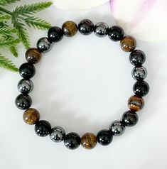 👉🏻All of my items are made with genuine, natural stones and crystals. Please be aware that no two stones are alike, that is what makes them unique. The size, colour and patterns of the beads will vary from piece to piece but these variations will not compromise the energy, beauty, and quality of your bracelet. This gemstone bracelet features 4 trendy gemstones for men: ⭐️ Shungite is a powerful stone that provides protection against electrosmog. It also absorbs negative energies and offers pro Hematite Beaded Bracelets With Natural Stones As Gift, Hematite Round Beads Bracelets For Healing, Hematite Round Beads Bracelet For Healing, Obsidian Round Beads Crystal Bracelet As Gift, Black Hematite Crystal Bracelet Spiritual, Black Hematite Crystal Bracelet For Spiritual Use, Black Hematite Spiritual Crystal Bracelet, Black Spiritual Hematite Crystal Bracelet, Hematite Bracelets With Natural Stones For Gift