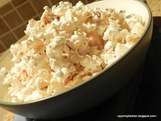 a bowl filled with popcorn sitting on top of a table