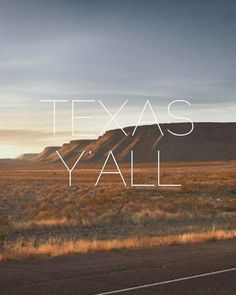 the words texas y'all written in white on a desert landscape