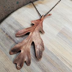 Real Oak leaf is copper electroformed and has an added patina. The pendant is then finished with a coating of clear enamel spray to protect the color and also to prevent the copper from discoloring skin from oxidation. *24 inch chain with a lobster clasp is included. Chain is made of iron with a dark silver color plating.  *You will receive this exact copper leaf pendant.  CREATING PROCESS  Handmade and created from a real leaf that I have found outside or from one of my plants. Each piece goes Brown Patina Necklace For Gift, Oak Leaf Jewelry, Real Leaf, Copper Leaf, Real Leaves, Skin Discoloration, Leaf Jewelry, Oak Leaf, Leaf Necklace