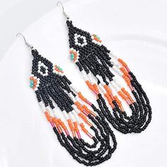 Approx 5" Handcrafted Bohemian Tassel Fringe Dangle Earrings Multicolored In Black Orange And White Boho Statement Jewelry Most Of My Other Earrings Are Dangle Types (Like These) That Can Be Upgraded To Solid Sterling Silver Or 14k Gold Filled Wires. I Have Some Extra Stainless Steel Wires And Gold Tone Wires Too. If You Want To Switch Out The Wires To One Of Those I Will Customize Them For You For Free. I Have A Background In Jewelry Design In Nyc And I Buy My Ear Wires From A Legitimate Metal Orange Bohemian Beaded Earrings For Parties, Black Festival Chandelier Earrings With Dangling Beads, Bohemian Orange Beaded Earrings For Party, Black Bohemian Chandelier Earrings For Festival, Black Beaded Earrings With Dangling Beads For Beach, Bohemian Orange Beaded Party Earrings, Black Beaded Earrings With Tassels, Black Tassel Earrings With Dangling Beads For Festival, Traditional Black Chandelier Earrings With Dangling Beads