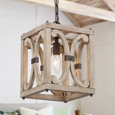 a wooden light fixture hanging from a ceiling