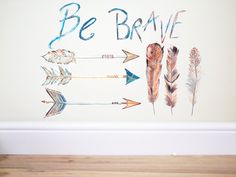 there are arrows and the words be brave painted on the wall above them is an arrow