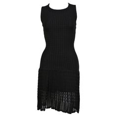 Jet black knit wool dress with semi sheer crocheted detail from Alaia dating to the 1990's. Labeled a size small. Measures approximately (unstretched): 12.75" at shoulders, 26" at bust, 20" at waist, 30" at hips, and 36" in overall length. Very soft and stretchy knit. Center back zipper. Hidden shorts with snap crotch. Made Italy. Very good condition. Azzedine Alaia Dress, Alaia Dress, Wool Knitted Dress, Sleeveless Knit Dress, Azzedine Alaia, 1990s Fashion, Black Knit Dress, Sleeveless Knit, 90s Dress