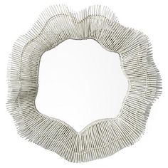 a mirror that is made out of sticks and has a circular shape on the front