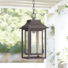 a lantern hanging from the ceiling on a porch