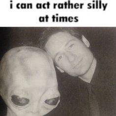 two men are posing for a picture with an alien head on their face and the caption says, i can act rather silly at times