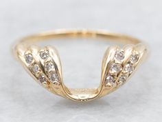 a yellow gold ring with diamonds on it