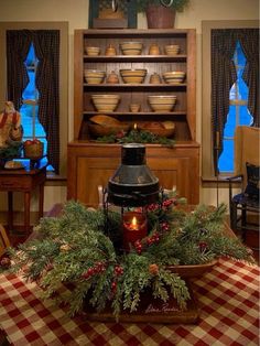 a christmas centerpiece with pine cones and berries