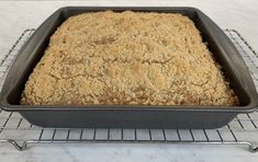 a baking pan filled with food on top of a metal rack