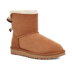 UGG Women's Mini Bailey Bow II Chestnut 1016501-CHE Silky bows added to an icon for a sweet, feminine take. Crafted with soft sheepskin, this versatile boot incorporates a durable, ultra-lightweight sole to increase cushioning and traction. Pair with practically anything, from athleisure wear to flowy dresses. These provide comfort for people who suffer from bunions, plantar fasciitis, metatarsalgia, heel spurs, or other types of foot pain, such as heel, arch, ball of foot, knee or back pain. DI Ugg Mini Bailey Bow, Mini Baileys, Flowy Dresses, Casual Slip On Shoes, Bailey Bow, Ugg Mini, Ugg Slippers, Athleisure Wear, Classic Boots