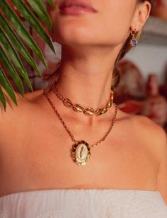 "There are 2 necklaces in this listing! Introducing our captivating choker, meticulously crafted with interconnecting golden shells adorning its 15\"/36cm length. With an elegant anatomical lobster clasp and a 3\"/10cm lengthening chain at the tip, this choker is as comfortable as it is stylish. Finished with luxurious gold plating, it's sure to make a statement wherever you go! We also have our delightful chain necklace adorned with a stunning cowrie shell medallion! Fastened with an anatomical clasp, it's not just stylish, it's a breeze to wear. With a perfect length of 17\"/42cm and a charming 3\"/10cm lengthening chain, all bathed in radiant gold plating, this necklace is sure to bring sunshine to your day! Welcome to Avinzia! Discover beautifully crafted jewelry designed to exceed you Handmade Gold Ocean-inspired Charm Necklaces, Handmade Ocean-inspired Gold Charm Necklaces, Gold Ocean-inspired Pendant Jewelry, Ocean-inspired Gold Pendant Jewelry, Handmade Gold Plated Chain Necklace, Mothers Day Jewelry, Necklace Measurements, Charm Choker Necklace, Shell Choker