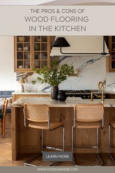 a kitchen with wooden cabinets and chairs around the counter top, along with an island