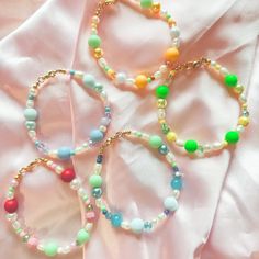 Due to the nature of the beads and variations in colors, the bracelet you receive may not be 100% identical to the one in the photo. ☁️ MATERIALS:  ☆ Durable sterling silver coated gold wire ☆ variety of beads ☆ Gold lobster clasp 📏 SIZING: The Strawberry Shortcake Inspired Bracelets, are 6.5 inches in length. If you would like to customize your size, message us prior to purchasing! 🍓 CARE:  Our bracelets can get wet, however we recommend to avoid water to maintain the quality and brilliance of the bracelet. If your bracelet does get wet, gently pat dry with a towel. Store in a dry, cool place, and avoid direct sunlight to avoid any fading in the colors.  Please do not overstretch the bracelets, as they may snap if stretched too far.  📦 SHIPPING: Orders $35+ free domestic shipping. Beca Pastel Bracelets With Colorful Beads For Gift, Pastel Colorful Beads Bracelets As Gift, Pastel Colorful Beads Bracelet As Gift, Playful Green Beaded Bracelets, Colorful Everyday Beaded Bracelets With Round Beads, Pastel Beaded Bracelets As Gift, Pastel Beaded Bracelets For Gift, Pastel Beaded Bracelets Gift, Trendy Handmade Pastel Bracelets