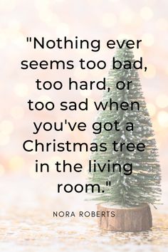 a small christmas tree sitting on top of a wooden stump with the quote nothing ever seems to bad, too hard, or too