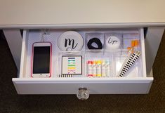 the drawers are organized with personal items such as pens, magnets, and cell phones