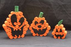 three carved pumpkins sitting next to each other