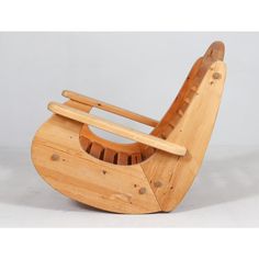 a wooden rocking chair that is made out of wood