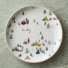 a white plate with houses and trees on it