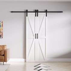 a living room with a couch, chair and sliding barn door