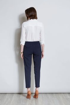 Sleek & timeless, this Slim Fit Ankle Pant is perfect for dressing up with its matching Single Button Blazer or pairing with Spring 's new knits and shirts. Featuring a slim leg & a pull on elastic back waistband, you will love the look & feel of these essential pants. T-Tahari Slim Fit Pant with Elastic Back Waistband Runs True to size Model is 5 '9 " and wearing a size S Imported Style #: THF17000A Classic Slim Fit Ankle-length Work Pants, Semi-formal Slim Fit Tapered Work Pants, Slim Fit Ankle-length Work Pants, Slim Fit Ankle-length Dress Pants With Welt Pockets, Fitted Elastane Pull-on Dress Pants, Single Button Blazer, Ankle Pants, Slim Fit Pants, Blazer Buttons