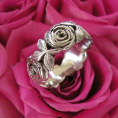 This is one of the few Designs of mine that I made for myself .  I spent a long time looking at , drawing then creating a realistic looking Rose .  I love the simplicity and classic design of my Rose Ring .  It is one of my most favourite Ring designs that I have created .... that is why I wear it as my Wedding Ring .   WIDTH  9.5 mm THICKNESS2.4 mm SIZE     Please contact me regarding Ring Size .    HALLMARKED 925  PLEASE NOTE This price is for a ring up to a size S in UK sizing  /   Size 9 1/8 in US sizing . A sizing fee will be charged for larger sizes than this ....   Contact me before you buy and I will give you an accurate price.  Please Note : Due to the nature of the Rose Ring it is impossible at times to make the ring alternate between a Rose and the Leaf designs ....  Depending o Two Roses, Silver Rose Ring, Pad Bag, Ring Hand, Rose Ring, Silver Wedding Rings, Love Rose, Rose Earrings, Favorite Rings