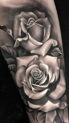 a black and white rose tattoo on the arm