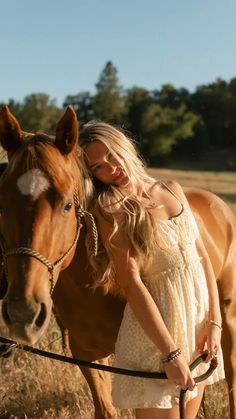 a woman standing next to a brown horse