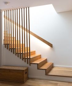 an empty room with stairs and wooden boxes