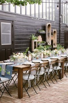 a long table set up with white and blue chairs