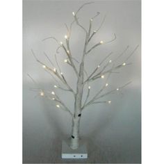 a small white tree with lights on it