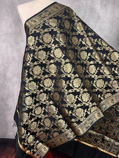 Gorgeous Black Color floral Jaal Banarasi Dupatta with Muted Gold Zari Weave. Dupatta is Soft and will add beauty to any Outfit. Makes a Perfect Gift! Please note - Dupatta has black color tassles on the ends. Item: DupattaColor : Black with Muted Gold Zari Weaving Fabric : Banarasi Silk (Non Pure Silk)Work : Zari Weaved with tassels Length of the dupatta : 88 inches (approx)Width of the dupatta : 35 inches (approx)Store Policies- No return or exchange will be accepted for color variations.- No Benarasi Dupatta, Designer Dupatta, Weaving Fabric, Facebook Black, Stole Scarf, Nehru Jackets, Floral Designer, Readymade Blouse, Indian Wear