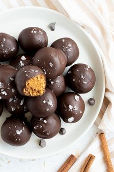 chocolate covered candies on a plate with cinnamon sticks