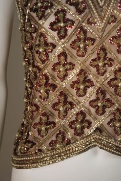 For Sale on 1stDibs - This Galanos blouse is composed of a beaded and sequin appliqued silk, in gold and burgundy hues. The top features a 3-dimensional beading technique. There Elegant Gold Embroidered Sequin Fabric For Festive Occasions, Glamorous Tops With Sequins For Reception, Elegant Burgundy Tops For Evening, Embroidered Gold Silk Top, Gold Embroidered Silk Top, Glamorous Embroidered Evening Tops, Red Embellished Evening Blouse, Glamorous Embroidered Tops For Evening, Red Embellished Blouse For Evening