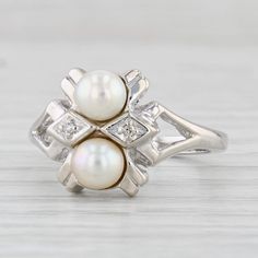 Gemstone Information: - Cultured Pearls - Size - 4.8 mm Cut - Round Bead Shape Color - White - Natural Diamonds Accents Metal: 14k White Gold  Weight: 4 Grams  Stamps: 14k Face Height: 11.9 mm  Rise Above Finger: 6.7 mm Band / Shank Width: 1.9 mm This ring is a size 4 3/4, but it can be resized up 3 sizes for a $30 fee. If you would like your ring resized, please select the appropriate fee from the listing below in order to pay the sizing fee: https://www.etsy.com/listing/781388346/ring-sizing-service-fee Each piece is thoroughly examined and refinished as needed by our professional jewelers, graded by our in-house GIA (Gemological Institute of America) Graduate Gemologist, and inspected for quality before being carefully packaged and promptly shipped. [SKU: B28686] phd Classic Multi-stone Diamond White Jewelry, White Gold Cluster Jewelry Stamped 14k, Classic Multi-stone Jewelry In Diamond White, Classic Round Multi-stone Jewelry, Classic Cluster Jewelry In 14k White Gold, Estate Style Round Jewelry Gift, Cluster White Gold Jewelry Stamped 14k, Elegant 14k White Gold Stamped Jewelry, 14k White Gold Multi-stone Jewelry For Anniversary