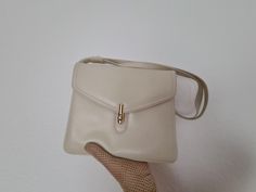 Vintage cream-colored handbag from the early 60s. A shoulder strap can be individually adjusted. The inside of the bag is lined with brown imitation leather. Star International Made in West Germany. The bag is closed with a rotary button and has four main compartments, one of which has a zipper. It is in very good vintage condition and is at least 50 years old. Height: 22cm Width:24cm Depth:6 cm Strap:60-115 cm Vintage Cream Leather Shoulder Bag, Vintage Cream Shoulder Bag With Detachable Handle, Vintage Beige Shoulder Bag For Office, Vintage Cream Shoulder Bag With Adjustable Strap, Vintage Cream Shoulder Bag For Everyday, Cream Vintage Shoulder Bag For Everyday Use, Elegant Beige Shoulder Bag With Snap Closure, Vintage Cream Satchel For Travel, Vintage Beige Formal Shoulder Bag